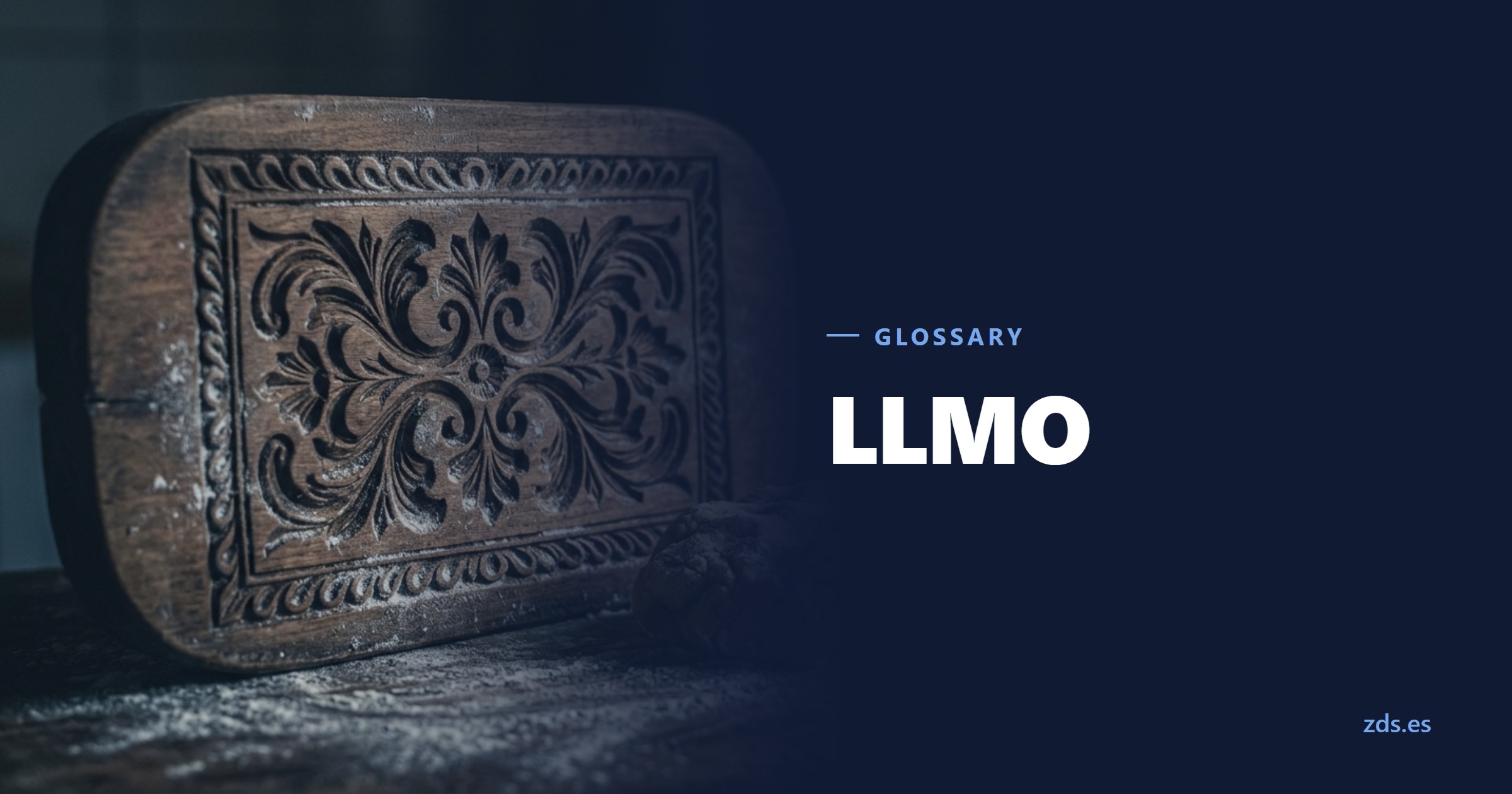 A carved wooden baking mould with an ornamental pattern, dough beside it — beside the title LLMO